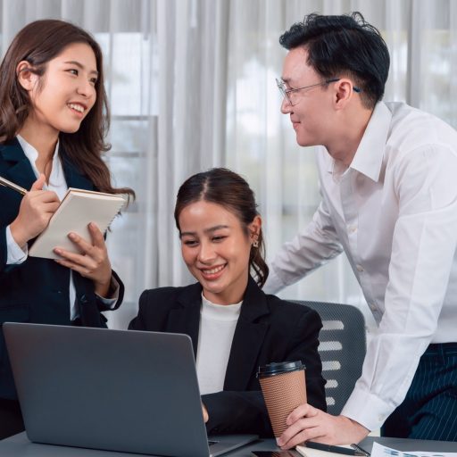 Harmony in office concept as business people analyzing dashboard paper together in workplace. Young colleagues give ideas at manager desk for discussion or strategy planning about project.